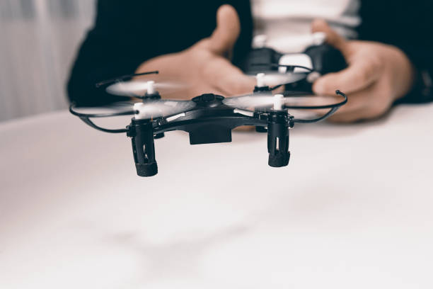 istock Boy Playing With A Small Quadrocopter Drone Close-up. 643120204