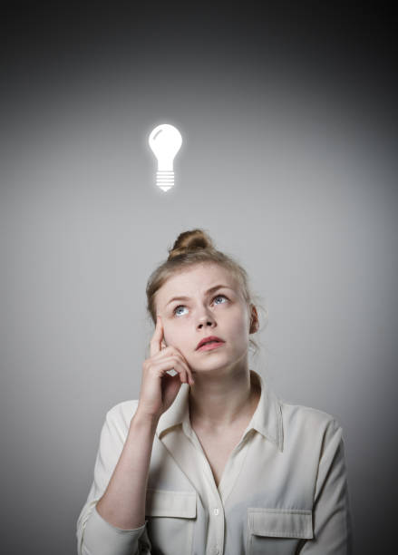 istock Girl in white and light bulb 643132900