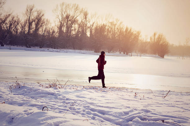 istock Jogging, push ups and stretching on cold winter day in snow 643136676