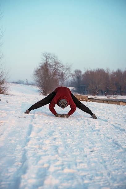 istock Jogging, push ups and stretching on cold winter day in snow 643136954