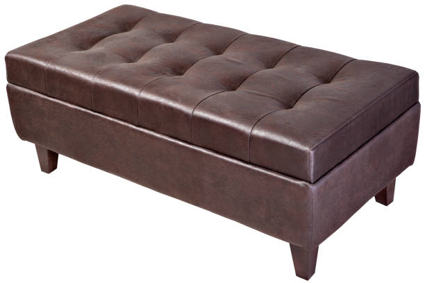 istock Modern, dark brown, button tufted leatherette bench ottoman upholstered, isolated. 643145984