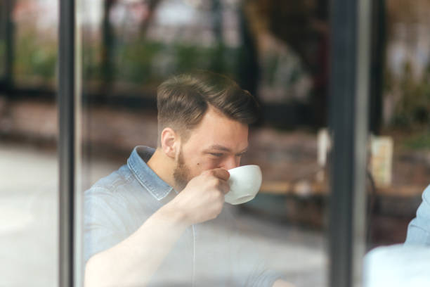 istock Smiling Young man Sitting at the Cafe 643148598