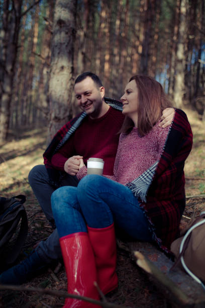 istock Beautiful couple with backpacks is having fun on the forest 643153308