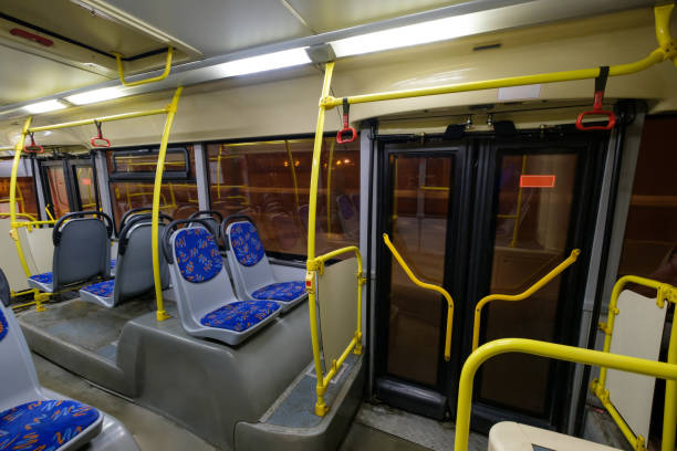 istock Interior of modern city bus with seats, doors and handles 643154114