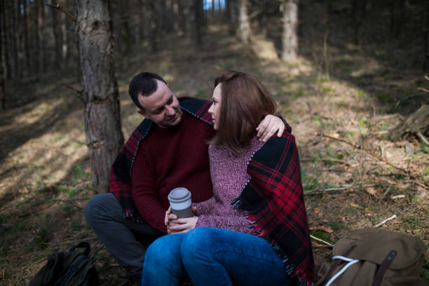 istock Beautiful couple with backpacks is having fun on the forest 643154236