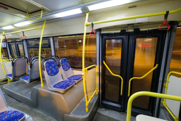 istock Interior of modern city bus with seats, doors and handles 643154378