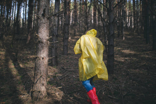 istock Autumn female in raincoat walking a forest 643154656