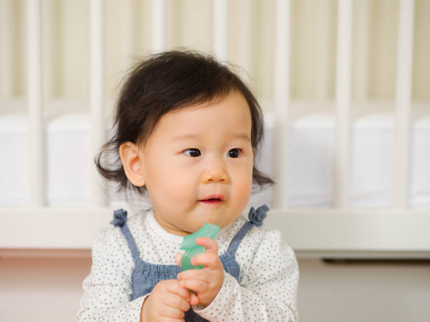 istock baby girl brushing her teeth 643154954