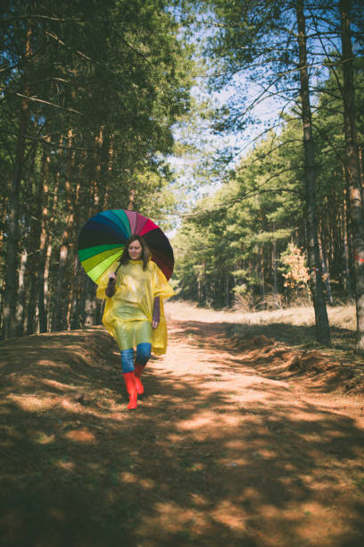 istock Woman with umbrella wearing rubber boots 643166702