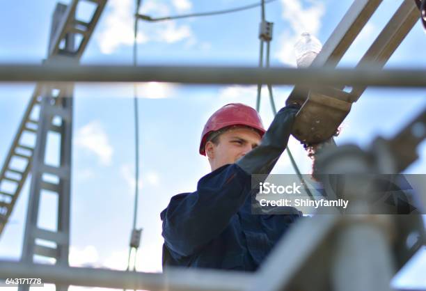 Electrician Working In Hight With Protective Equipment Stock Photo - Download Image Now