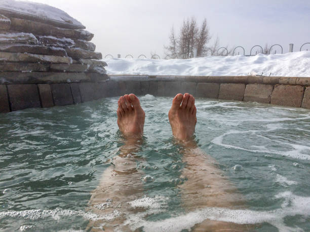 istock POV of two feet floating in spa 643172582