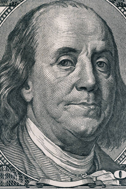 istock Vertical portrait of Benjamin Franklin's face on the US 100 dollar bill. Macro shot 643178106