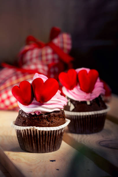 istock Cupcakes with white cream and red hearts 643182110