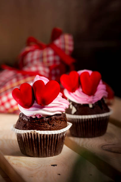 istock Cupcakes with white cream and red hearts 643182118