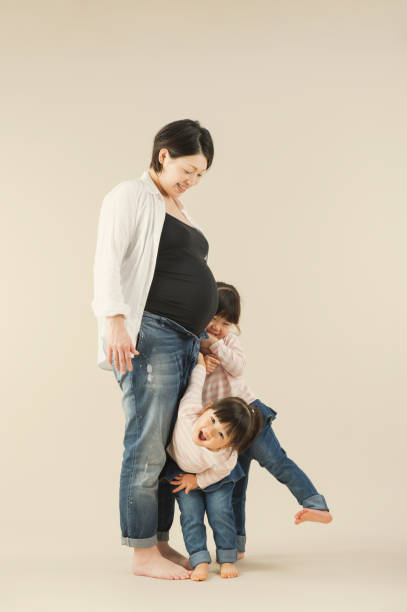 istock Pregnant mother and two sisters in studio 643209348