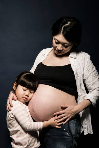 istock Pregnant mother and her daughter in studio 643209380