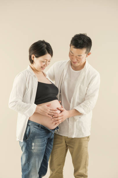 istock Man hugging pregnant wife 643211918