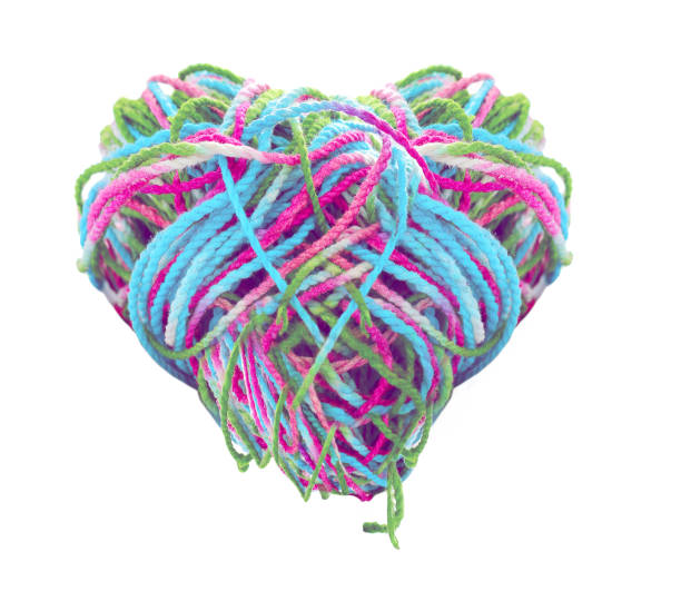 istock multicolored tangled yarn heart shape on white background. 643212582