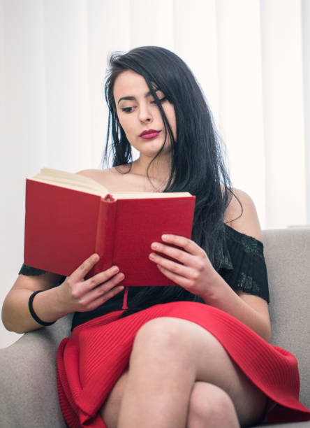 istock Cute woman reading a book 643227422