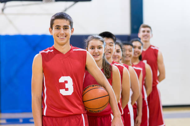 Mixed gender high school basketball team posing