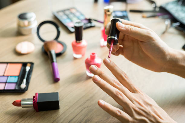 istock Girl doing nail pianting on dressing table and cosmetics 643235420