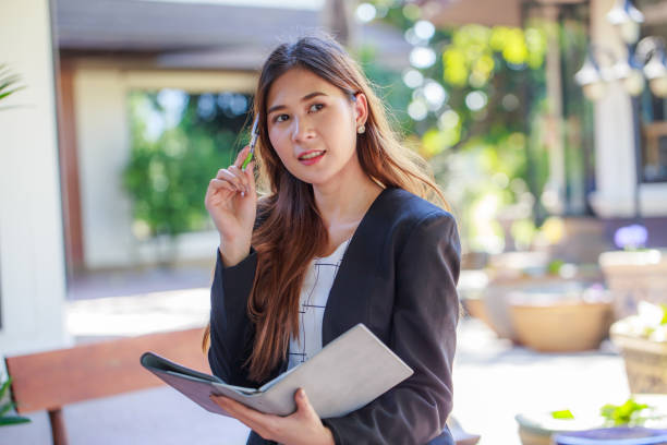 istock Pretty Asian young business woman thinking. 643237656