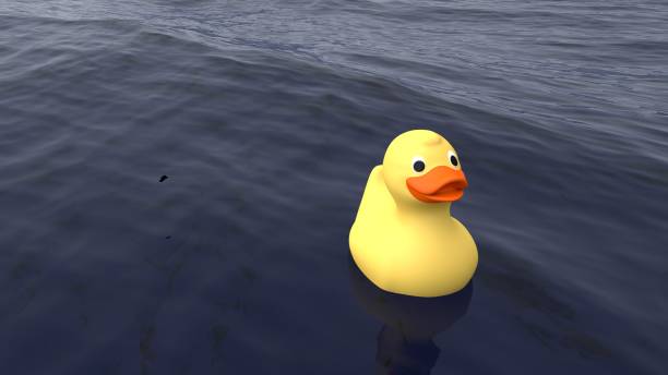 istock Lonely yellow rubber duck swimming on the ocean 643238754