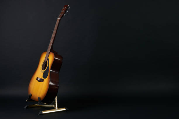 istock Acoustic guitar on a black background 643241180