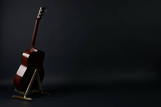 istock Acoustic guitar on a black background 643241750