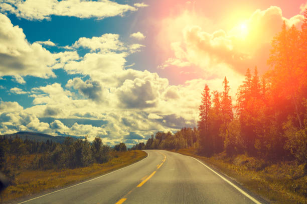 istock Mountain road at sunset with cloudy sky 643242574