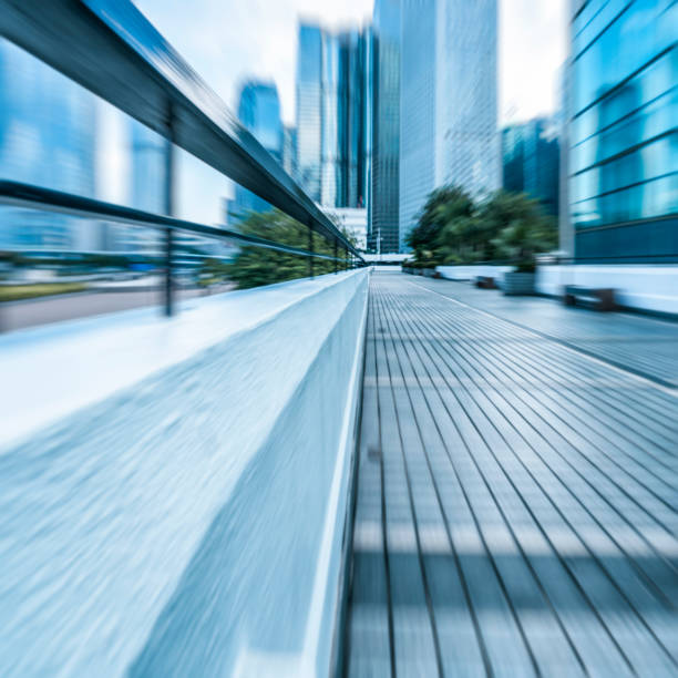 istock blurred pavement leading to modern buildings 643245034