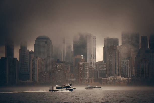 New York City downtown business district in a foggy day with ferry boat