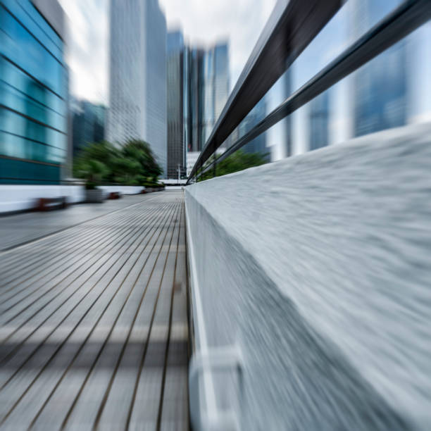 istock blurred pavement leading to modern buildings 643253996