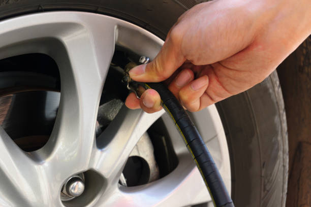 istock Inflating the automobile wheels via a pump 643254128