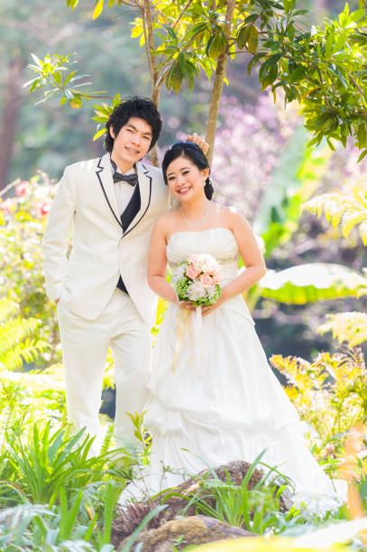 istock Asian Bride and Groom on Natural Background 643254352