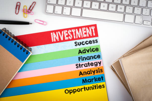 istock Investment. Office desk with a computer keyboard and color pages 643258346