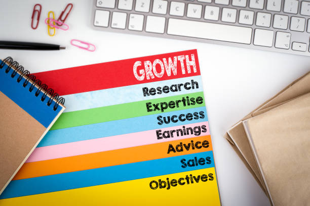istock Growth. Office desk with a computer keyboard and color pages 643258376