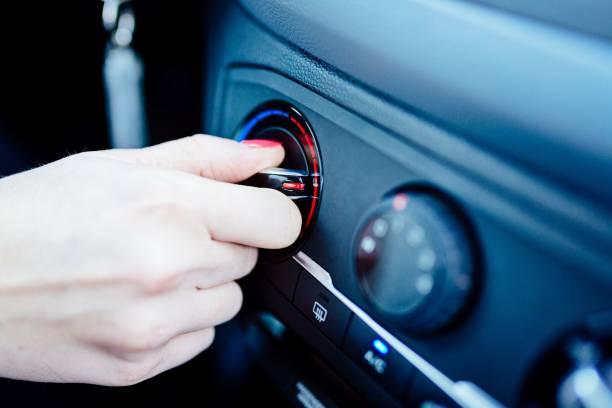 istock Woman regulates heating in her car. 643263858