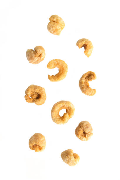 Falling pile of pork rind on white background.