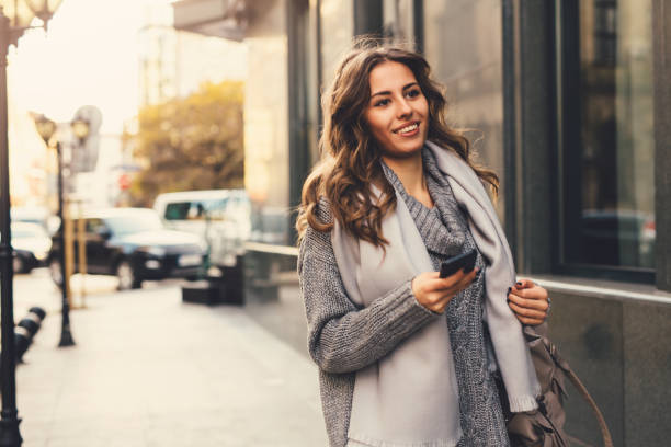 istock Woman texting outdoors 643268462