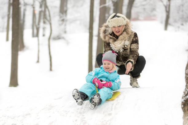 istock A three year on snow with grandma 643271418