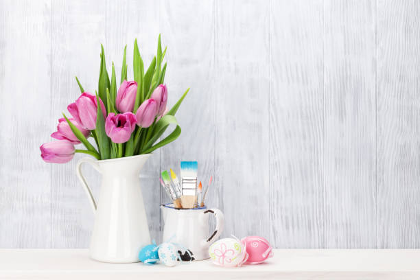 istock Easter eggs and pink tulips bouquet 643272952