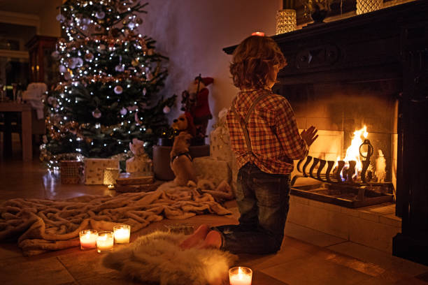 istock Young boy in christmas scene with festive decorations in indoor setting 643278370