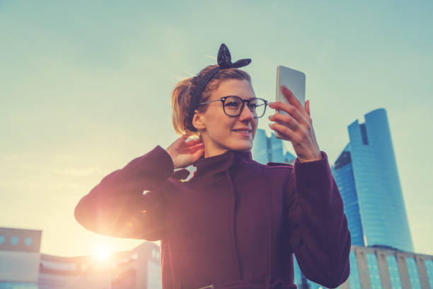 istock Girl using cellphone outdoors. 643292684