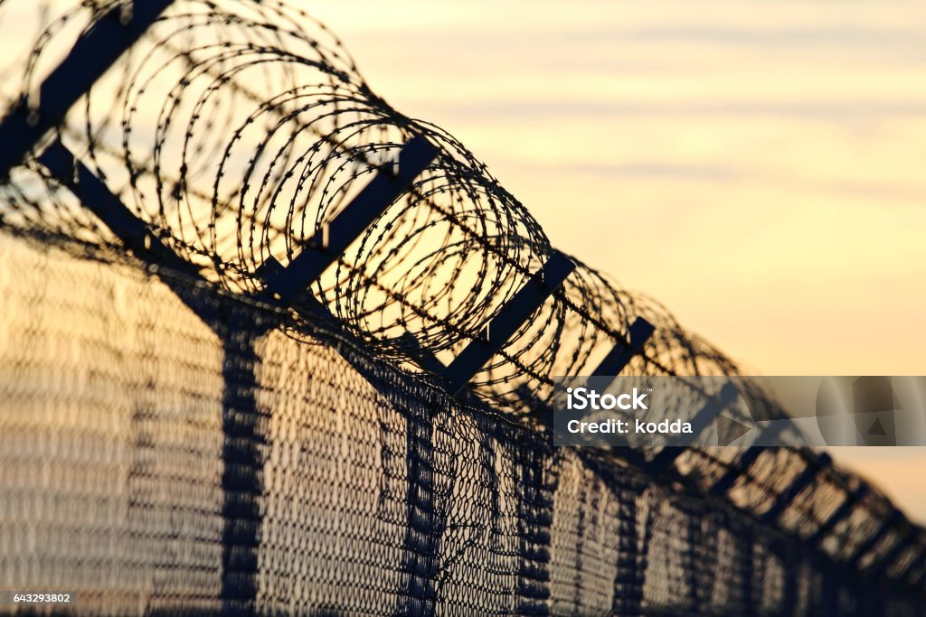barbed wire steel wall against the immigrations in europe Geographical Border Stock Photo