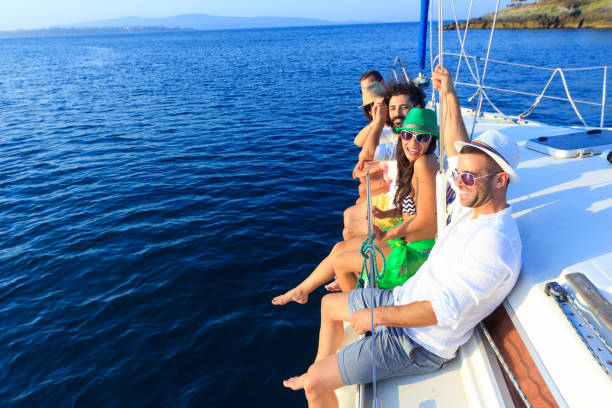 istock Cheerful young people having fun on yacht 643296656