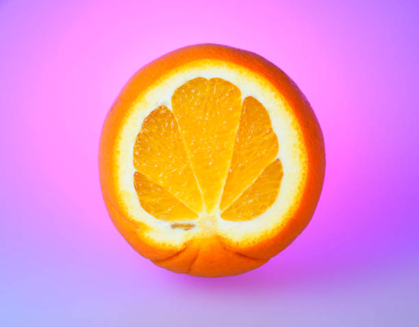 istock juicy orange on purple background. 643297100