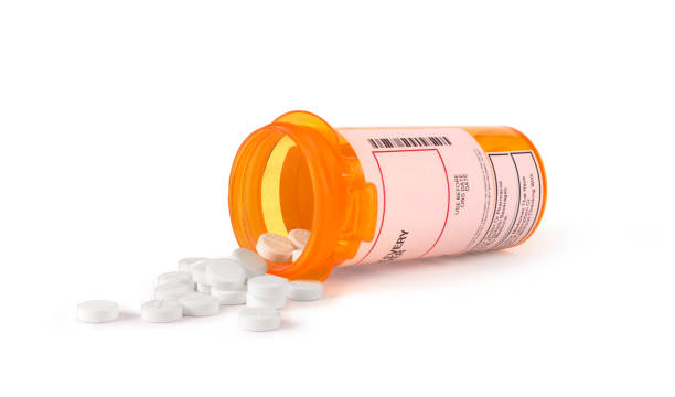 istock white pills in yellow bottle 643297318