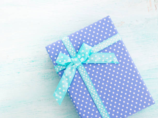 istock Blue gift box with ribbon pastel background. Fathers day 643300508