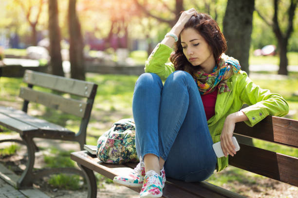 istock Lonely girl in the park 643305608
